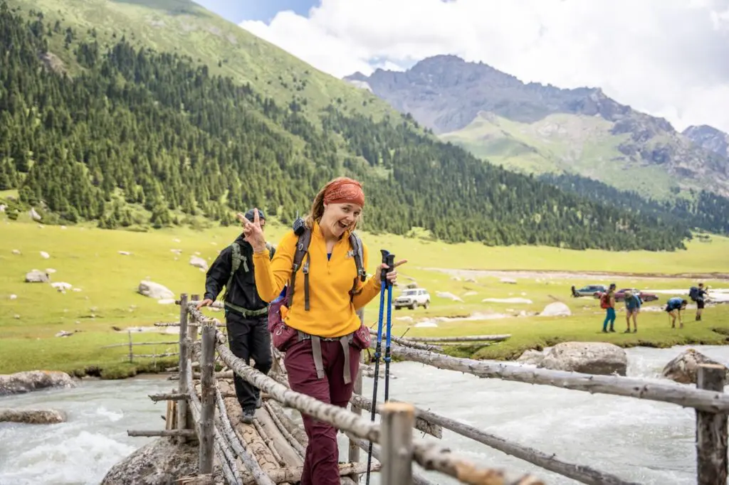 Smiling female hiker on a bridge in Kyrgyzstan