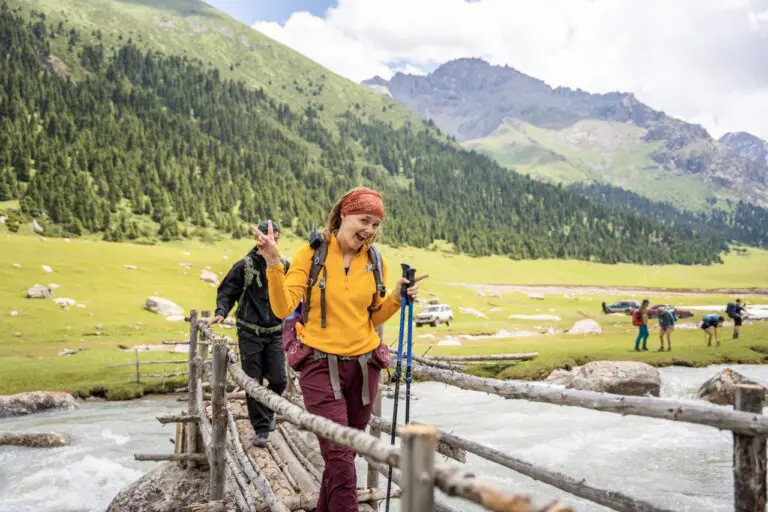 Smiling female hiker on a bridge in Kyrgyzstan