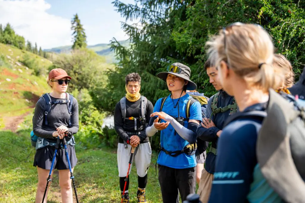 Group of hikers listening to their guide in a mountain landscape