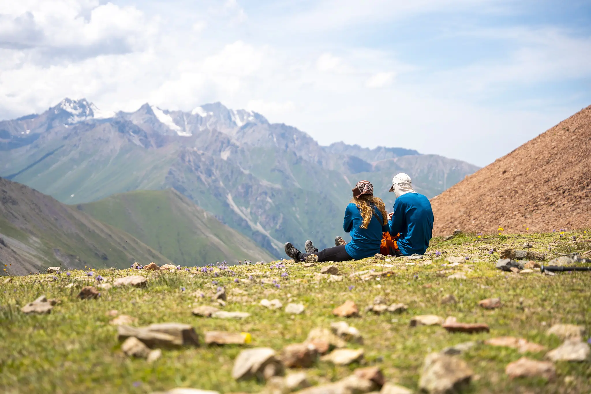 twee wandelaars die uitrusten op een bergkam in Kirgizië